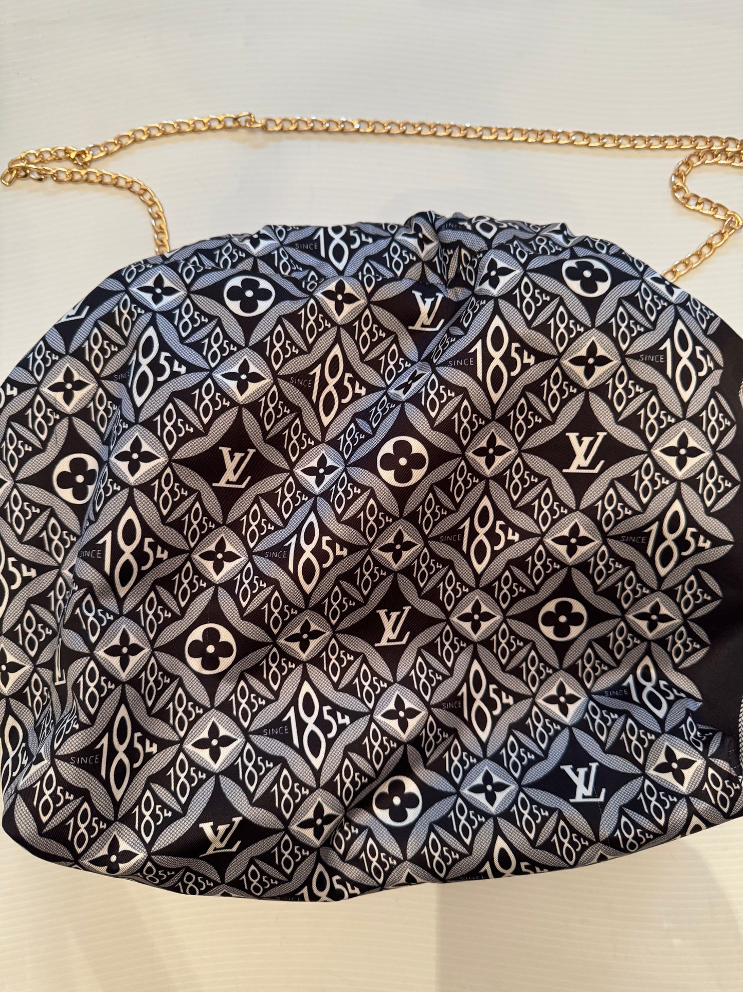 Vintage silk scarf reimagined as a clutch bag. Comes with chain shown