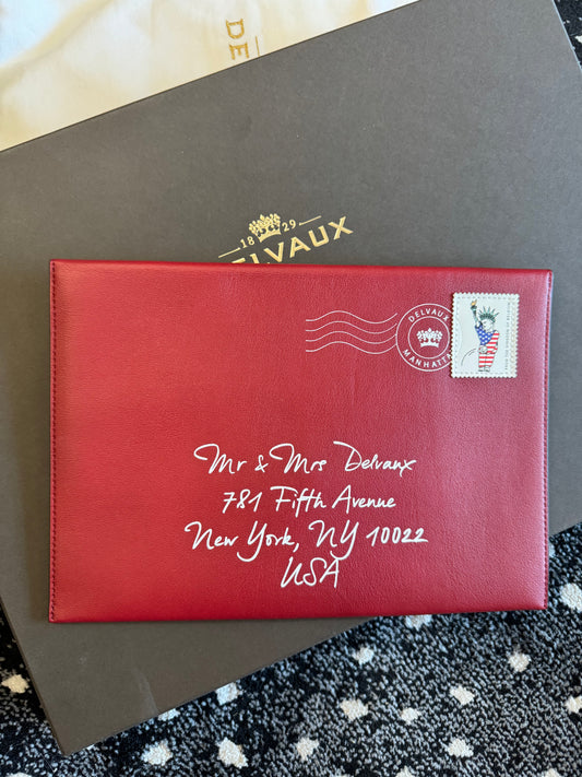 Brand new 2024 Crimson printed calf leather Delvaux Kiss NY Mr & Mrs Envelope Clutch with postage print suede interior. Includes dust bag and box.