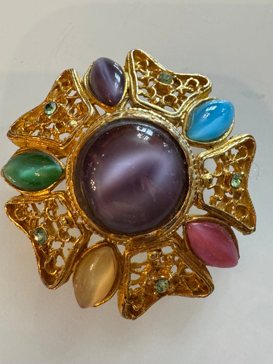 Beautiful vintage gold tone pendant with cabochon stones and green rhinestones