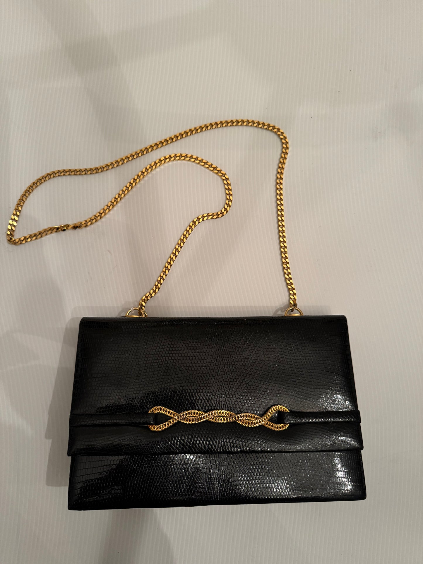 Elegant 1950s lizard black handbag with gold chain closure and gold tone chain shoulder strap