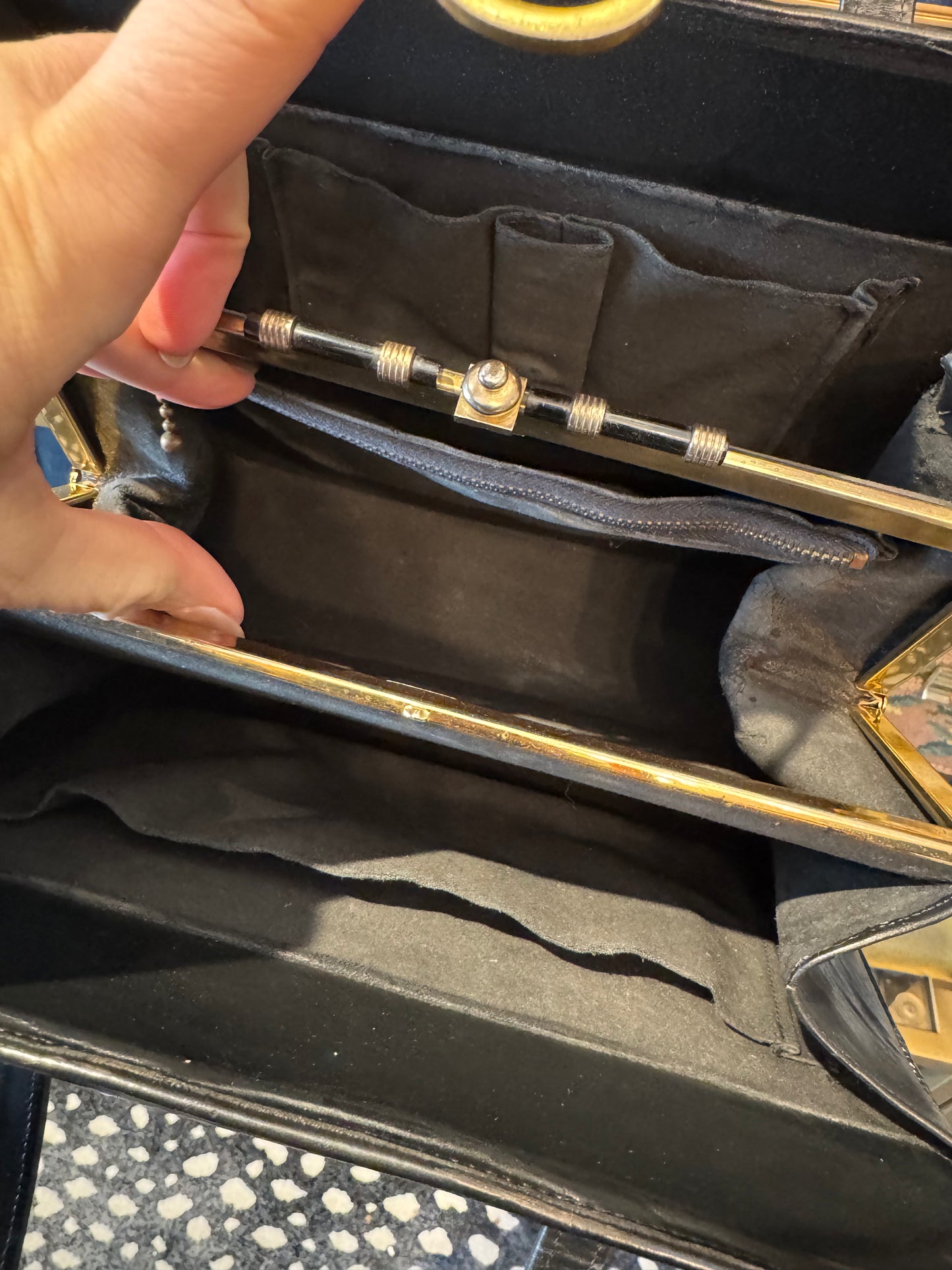 Fantastic 1960s faux leopard fur and black leather handbag. Beautiful interior hardware with three roomie compartments.