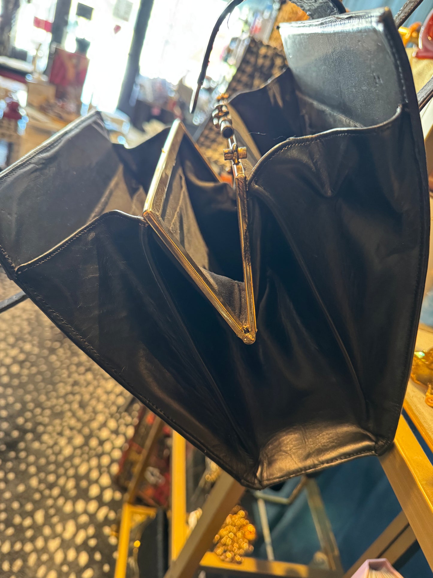 Fantastic 1960s faux leopard fur and black leather handbag. Beautiful interior hardware with three roomie compartments.