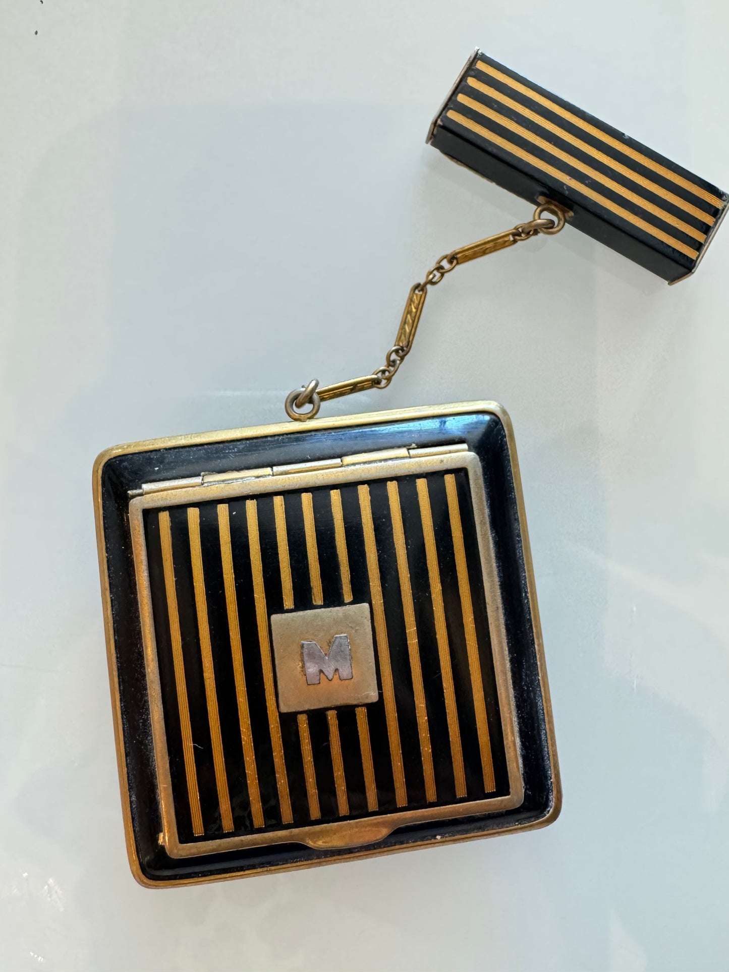 Enamel makeup compact with lipstick chain and initial "M" opens twice inside too