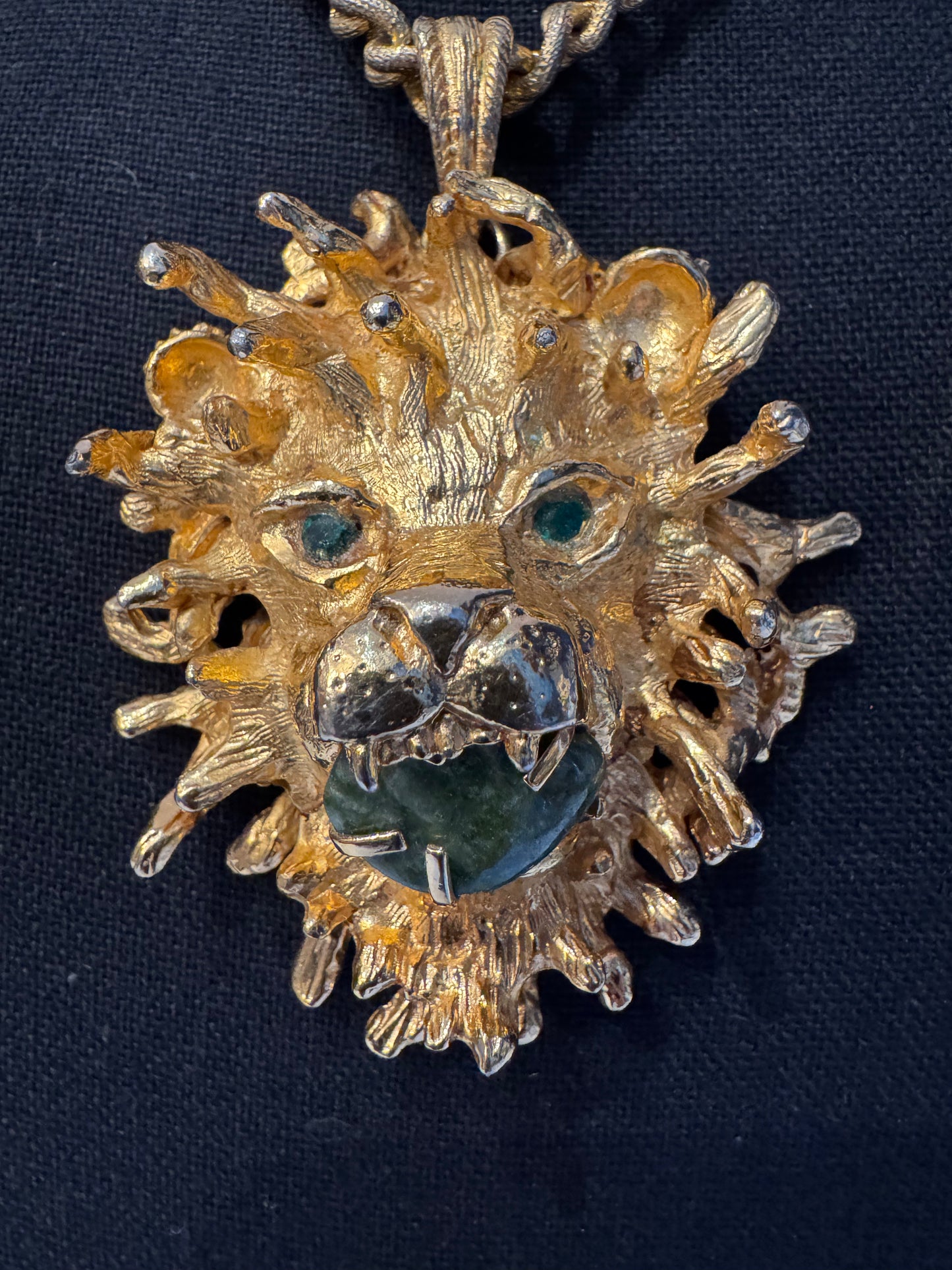 Vintage jumbo gold tone lion head pendant necklace with green eyes and stone in mouth