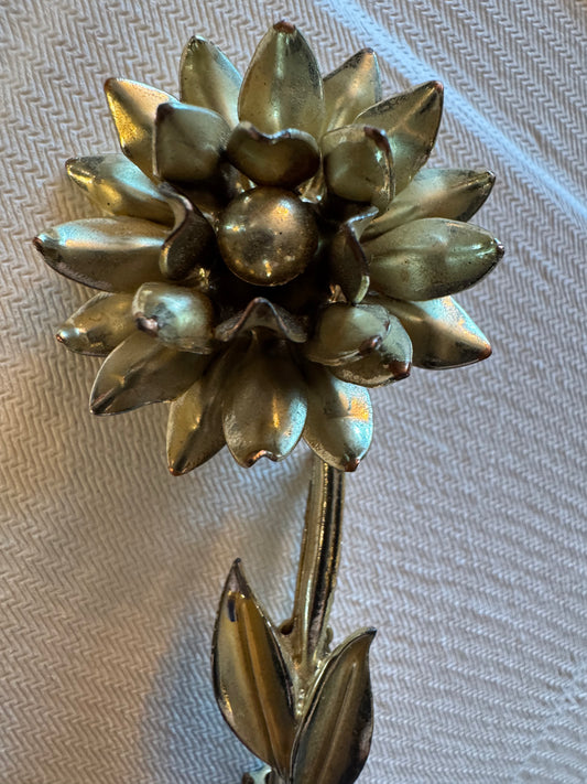 Gold tone vintage flower brooch with leaves and stem