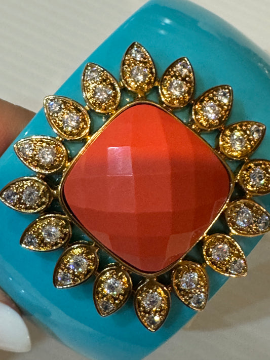 Early 2000s Kenneth Jay Lane turquoise colored CZ magnetic clamper/cuff bracelet. Coral colored center stone.