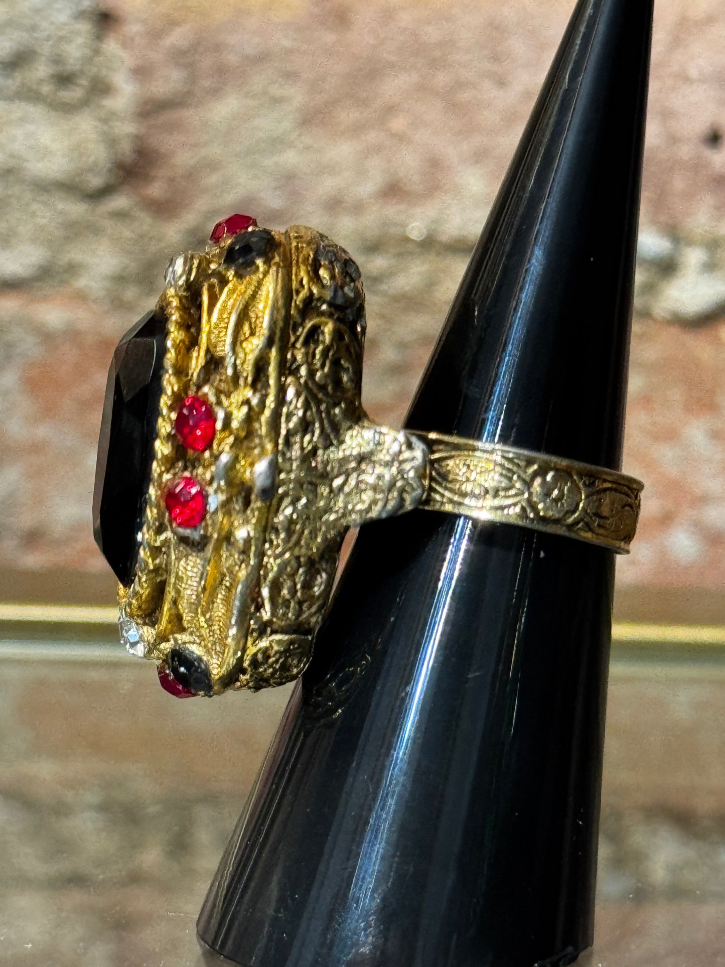Gorgeous 1960s "poison" gold tone with black cabochon and red rhinestone ring