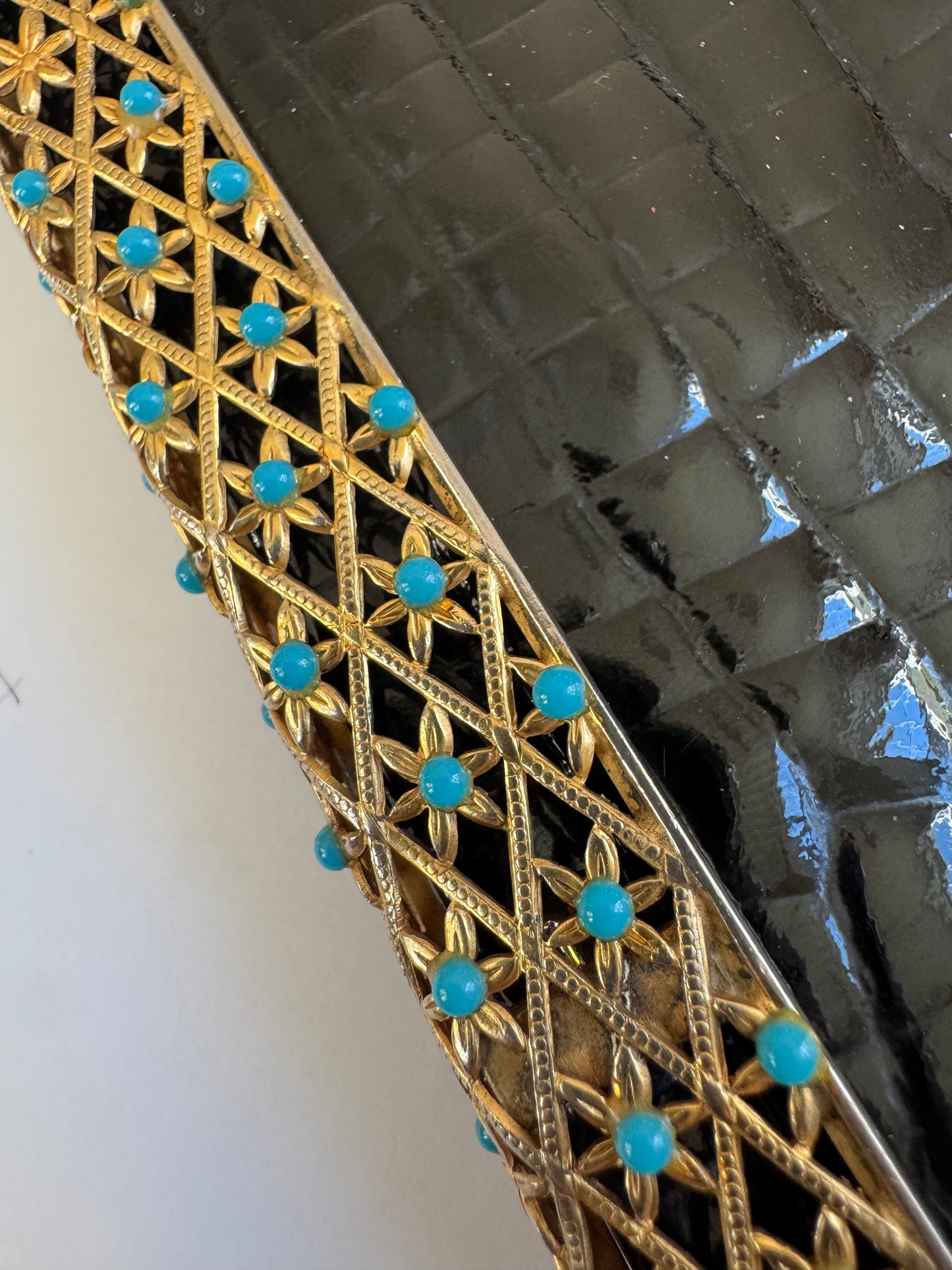 1950s glamorous black crocodile clutch with decorative flower closure in gold tone and turquoise