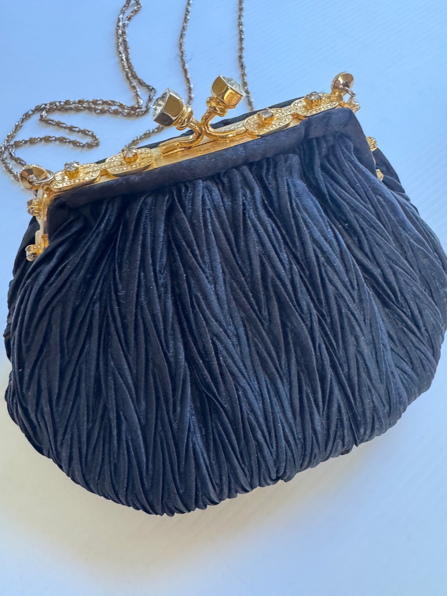 Elegant 1960s plisse black silk minaudiere evening bag with beautiful gold hardware and strap long enough for Crossbody