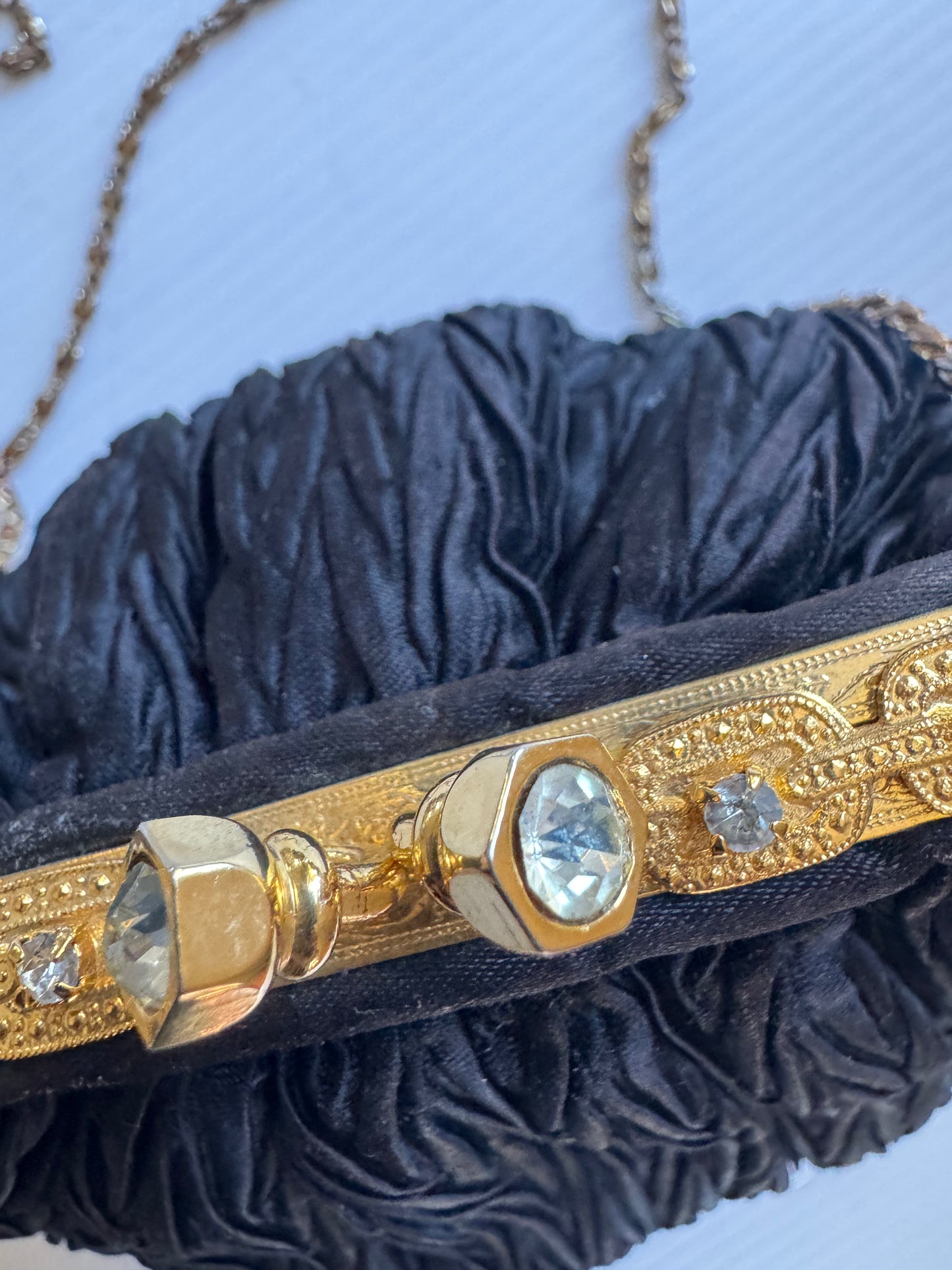 Elegant 1960s plisse black silk minaudiere evening bag with beautiful gold hardware and strap long enough for Crossbody