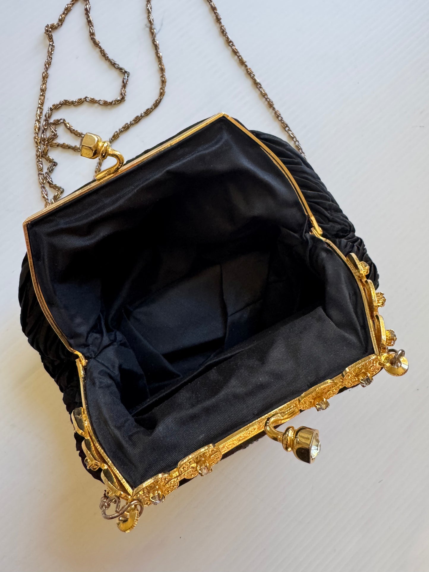 Elegant 1960s plisse black silk minaudiere evening bag with beautiful gold hardware and strap long enough for Crossbody