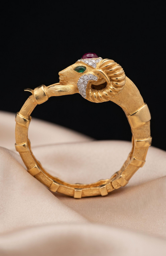 1970s Rams head, signed KJL clamper bracelet with rhinestones and green and red cabochons