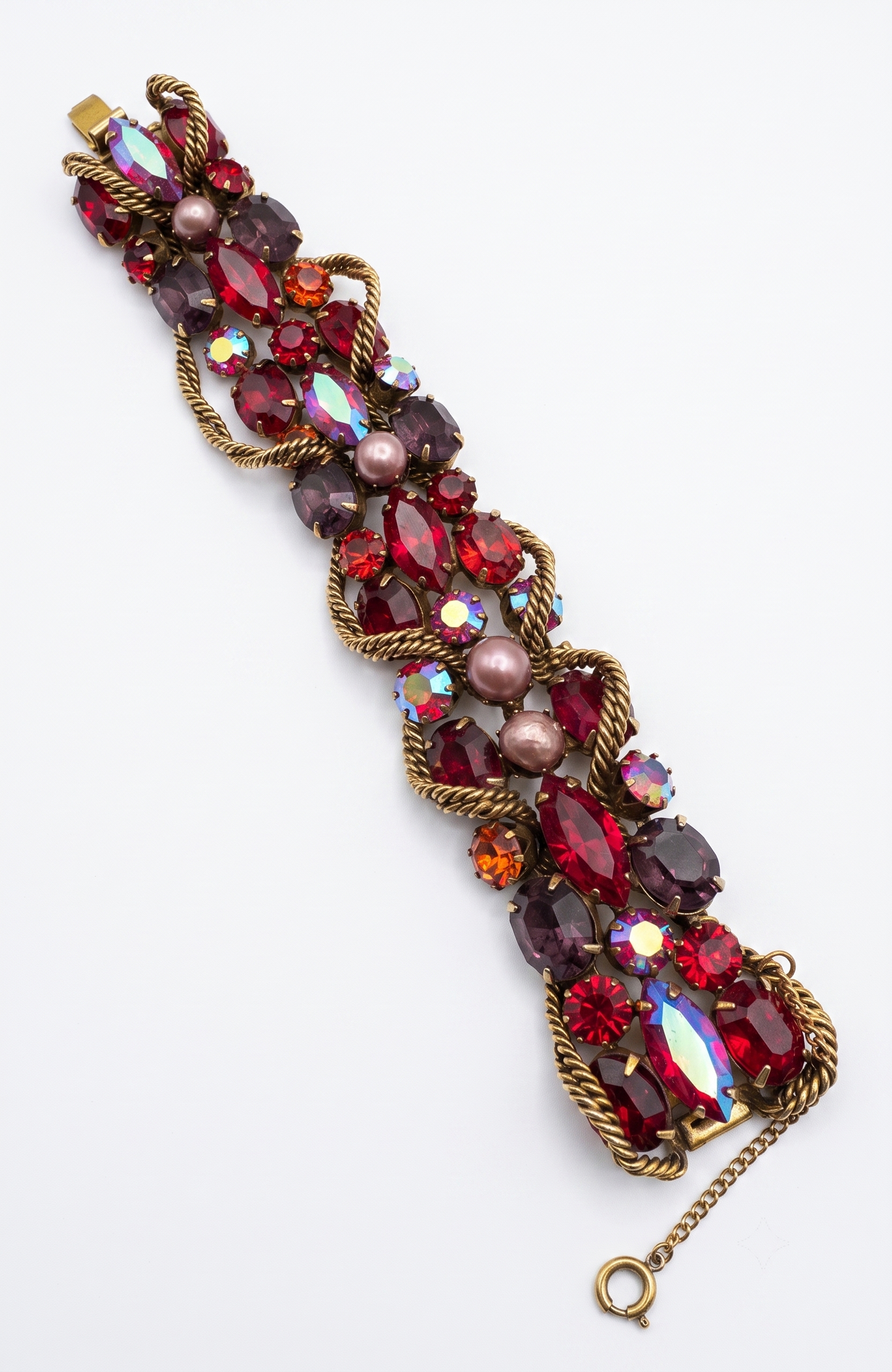 1950s signed KRAMER of NY rhinestone bracelet featuring red crystals and aurora borealis with a gold link chain throughout ￼