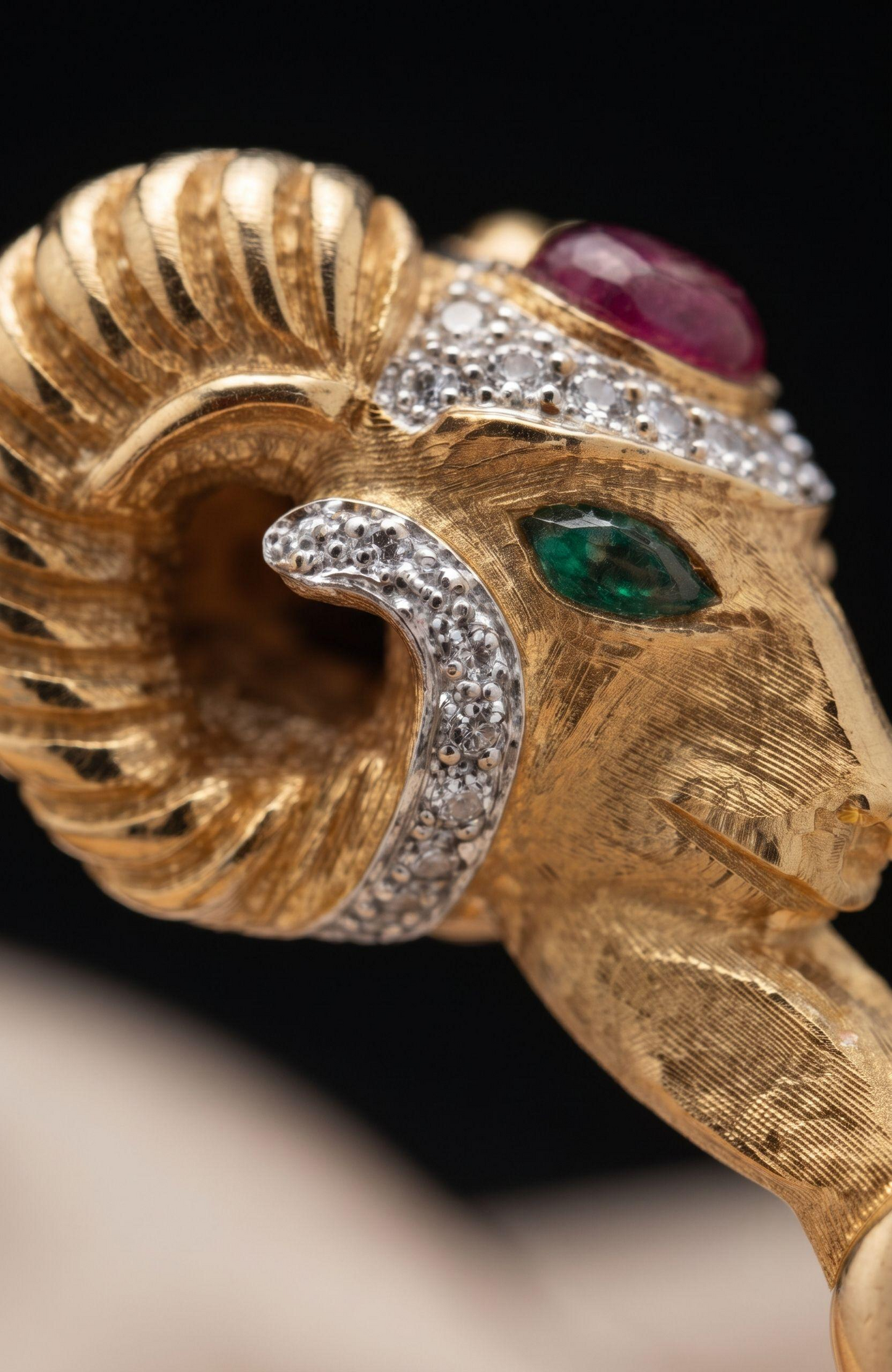 1970s Rams head, signed KJL clamper bracelet with rhinestones and green and red cabochons