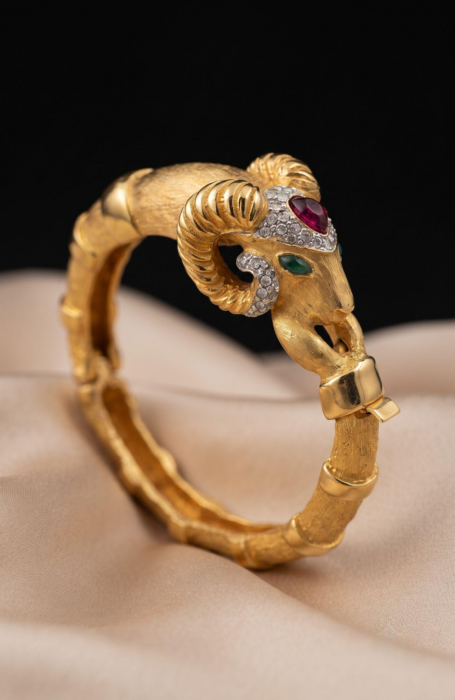 1970s Rams head, signed KJL clamper bracelet with rhinestones and green and red cabochons
